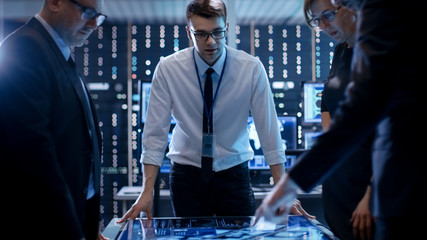 Three Government Agents Working at the Big Table in Monitoring Room. Room is Full of State of the...