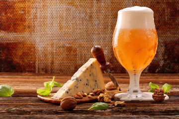 Blue cheese appetizer and beer on brown vintage background