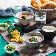 Beetroot soup served in bowls on napkin. Lunch with light vegetarian dish