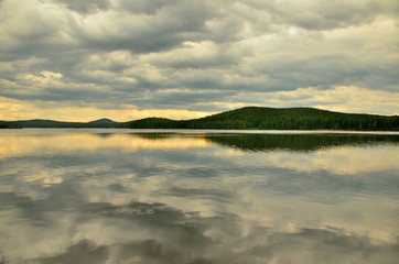 overcast on the lake and reflection of the clouds in the water