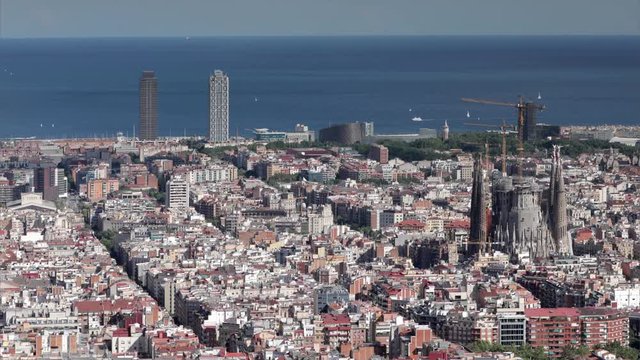 zoomed in shot focusing on a large hotel in barcelona shot from the bunkers de carmel offering amazing panoramic views over the city skyline