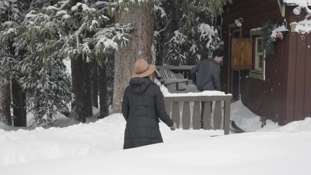 Man Shovels Snow Off Cabin's Porch, His Girlfriend Throws A Snowball At Him, Turns Into Snowball Fight