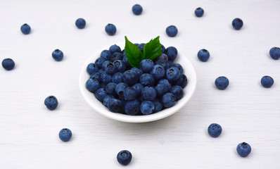 Freshly picked blueberries in a white bowl.