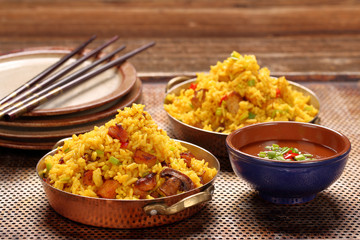 Chicken with basmati rice fried in stainless pan