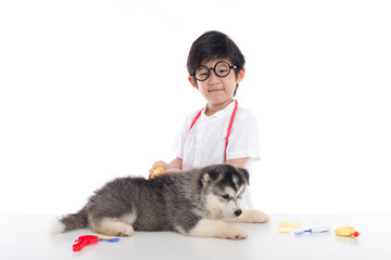 Asian child playing veterinarian