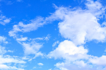 Naklejka na ściany i meble Blue sky background with white clouds on sunny summer or spring day.