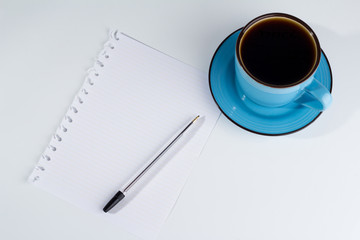 Paper, pen and black coffee.