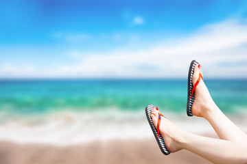 Naklejka premium female legs on the beach