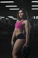 Fototapeta na wymiar Young sexy girl posing in gym.