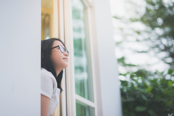 Fototapeta premium Asian girl look out the window