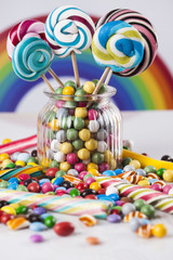 Colorful lollipops and different colored round candy and gum balls
