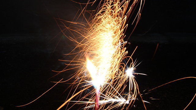 Abstract Texture Background of Fire Sparks With Motion Blur Effect Over Black Background. Slow Shutter