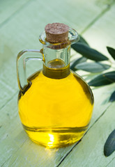 Olive oil in a bottle with olive leaves 