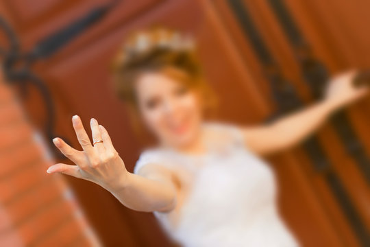 Happy bride shows ring on his finger.