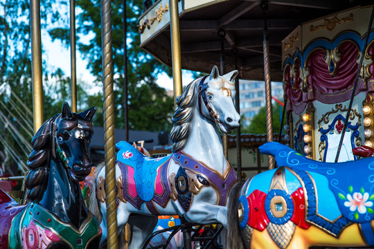 Beautiful horse Christmas carousel in a holiday park. Horses on a traditional fairground vintage carousel. Merry-go-round with horses.