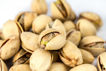 Salt pistachio nuts pile isolated on white background close up