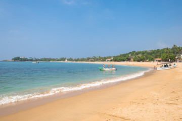 Fototapeta na wymiar At the beach of Unawatuna, one of the major tourist spots in the south west of Sri Lanka