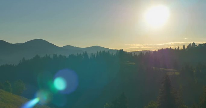 Sunrise or sunset in the mountains. Forest in the mountains. Panorama Beautiful pine trees on the background of high mountains.