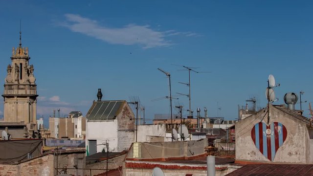 timelapse shot of the rooftops of barcelona shot from a terrace in the centre of the city. the weather this day was a mix of sun and storms creating interesting and beautiful skies