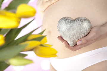 Close up of a cute pregnant belly, Heart