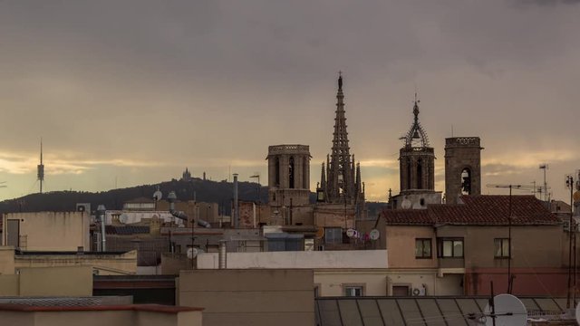 timelapse shot of the rooftops of barcelona shot from a terrace in the centre of the city. the weather this day was a mix of sun and storms creating interesting and beautiful skies