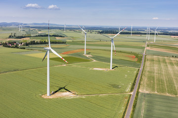 Obraz premium aerial view of the wind farm and harvest fields