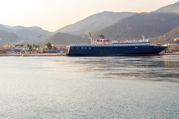 EMC lines cargo ship cruising on sunset in Greece, Corfu