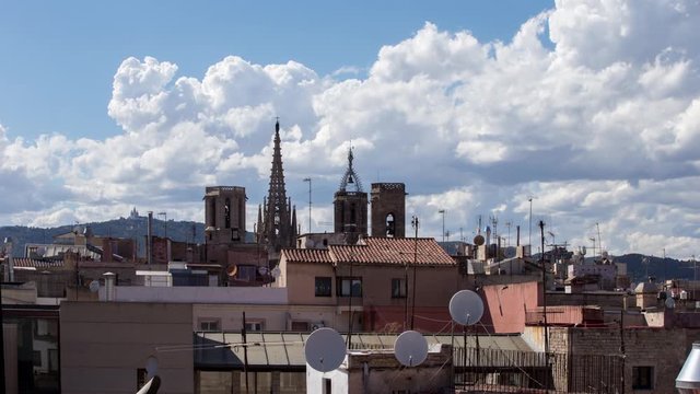 timelapse shot of the rooftops of barcelona shot from a terrace in the centre of the city. the weather this day was a mix of sun and storms creating interesting and beautiful skies