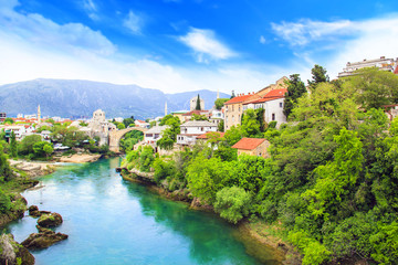 Fototapeta na wymiar Beautiful view Old bridge in Mostar on the Neretva river, Bosnia and Herzegovina, on a sunny day