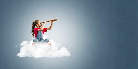 Concept of careless happy childhood with girl dreaming about future