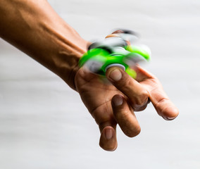 Hands spinner green spin on finger.