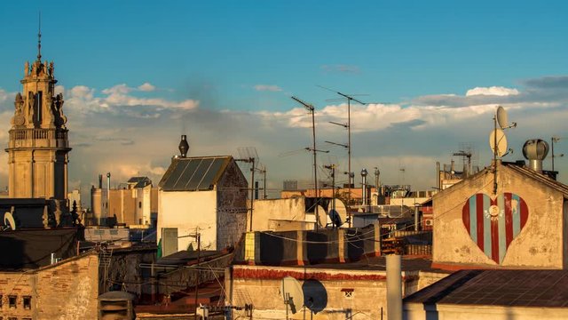 timelapse shot of the rooftops of barcelona shot from a terrace in the centre of the city. the weather this day was a mix of sun and storms creating interesting and beautiful skies