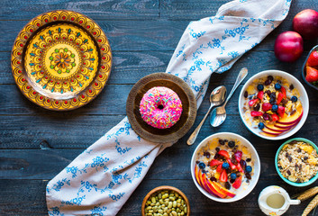 Healthy breakfast with milk,muesli and fruit, on a wooden background.