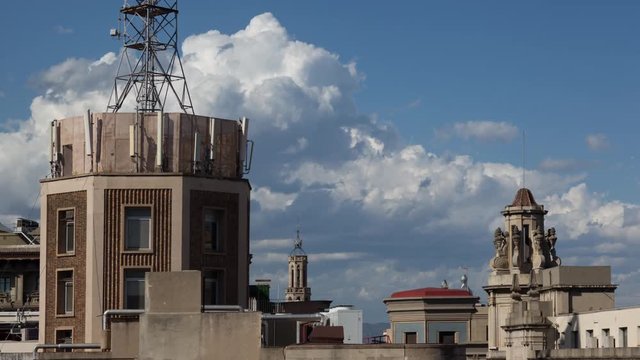 timelapse shot of the rooftops of barcelona shot from a terrace in the centre of the city. the weather this day was a mix of sun and storms creating interesting and beautiful skies