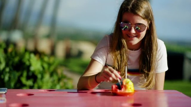 Happy Teen Girl Smiles And Takes A Bite Of Hawaiian Shaved Ice Treat, Maui, Hawaii