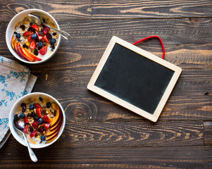 Obraz na płótnie Canvas Healthy breakfast with milk,muesli and fruit, on a wooden background.