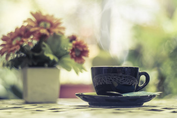Cup of coffee on table in cafe Morning light , vintage or retro color toned