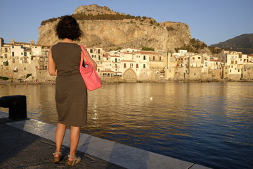 Woman admires the city of cefalu'