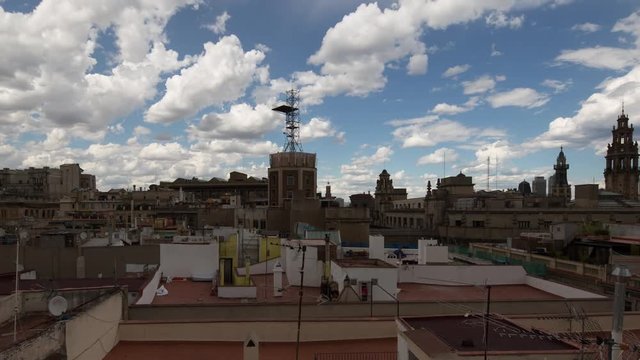 timelapse shot of the rooftops of barcelona shot from a terrace in the centre of the city. the weather this day was a mix of sun and storms creating interesting and beautiful skies