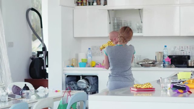 young mother puts baby in the buggy and choppy