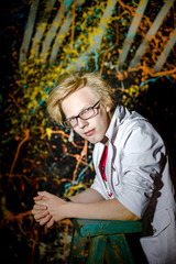 Funny teenage boy posing like a crazy professor or student