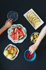 Two young women eating fruit and enjoying