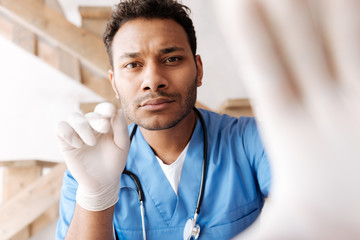 Very attentive dark-skinned bearded man consulting his patient