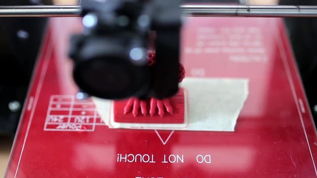 3d printer prints a figurine