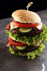 fresh tasty burger on wooden grey background