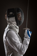 Woman fencer with Mask holding the sword in front of her