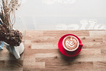 Coffee latte art on wooden table in coffee shop