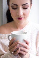 cup of coffee or tea in female hands