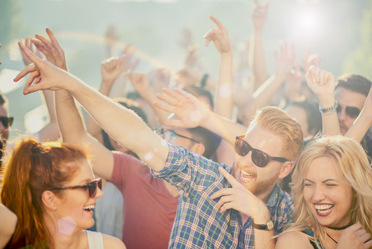 Big group of people dancing and having a good time at music festival