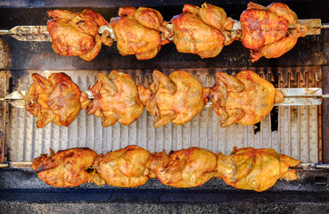 Rotisserie chicken on the grill at local street market
